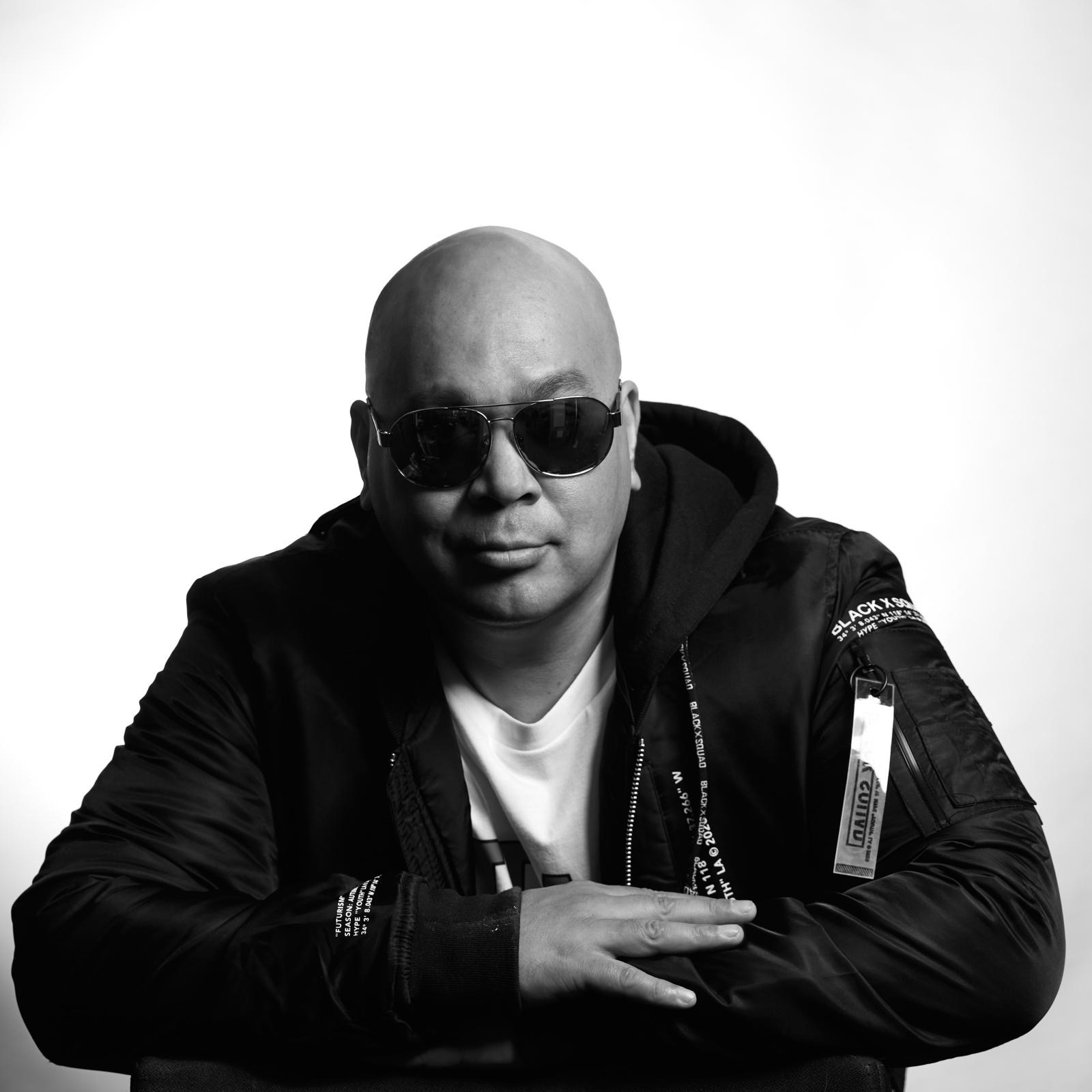 Ish Tiago with sunglasses, seated